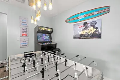 a game room with a table and a giant chessboard at Fanta Sea - Private Seasonal Hot Tub, Game Room, Walk to Beach, Pets OK, & More! in Panama City Beach