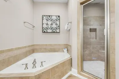 a white tub in a bathroom with a shower at Bella Costa 160- Sandy Feet Retreat in Panama City Beach