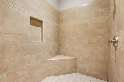 a bathroom with a shower with a tiled shower at Bella Costa 160- Sandy Feet Retreat in Panama City Beach