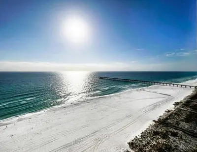 an aerial view of a beach with a pier at Emerald Chic BeachFront 2 bdr apt 4 beach seats and a cannope on us in Panama City Beach