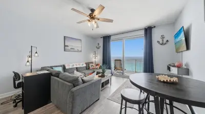a living room with a couch and a table at Emerald Chic BeachFront 2 bdr apt 4 beach seats and a cannope on us in Panama City Beach