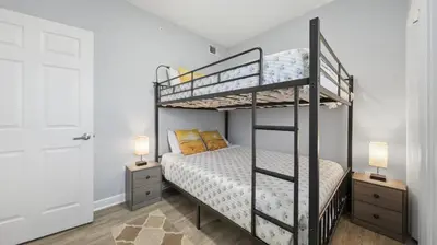 a bedroom with two bunk beds and two lamps at Emerald Chic BeachFront 2 bdr apt 4 beach seats and a cannope on us in Panama City Beach