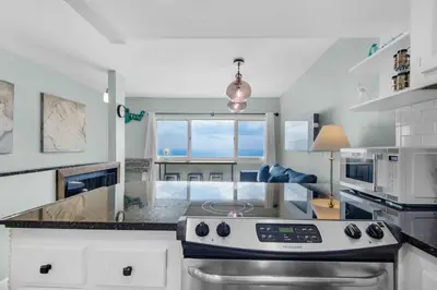 a kitchen with a stove top oven in a room at Pinnacle Port A-910 in Panama City Beach