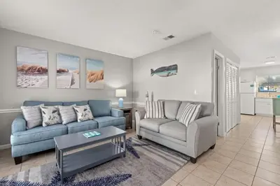 a living room with two couches and a table at Beach Haven - Seasonal Hot Tub, Fire Pit, BBQ, 700 Feet to Beach, Central PCB, FREE Daily Activities, & More! in Panama City Beach