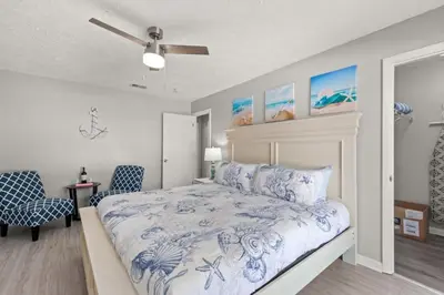 a bedroom with a bed and a ceiling fan at Beach Haven - Seasonal Hot Tub, Fire Pit, BBQ, 700 Feet to Beach, Central PCB, FREE Daily Activities, & More! in Panama City Beach