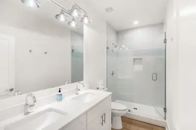 a white bathroom with a sink and a shower at The Eagles Nest in Rosemary Beach