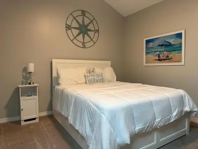 a bedroom with a bed with a white bedspread at St Thomas Square Villa 414 in Panama City Beach