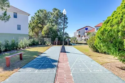 a sidewalk in a park with a street light at St Thomas Square Villa 414 in Panama City Beach