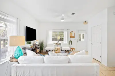 a living room with white furniture and a white couch at 30A Beach House - Coconut Cottage by Panhandle Getaways in Santa Rosa Beach