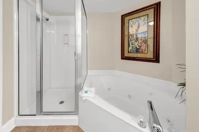 a white bathroom with a tub and a shower at Majestic Beach Towers 1-407 in Panama City Beach