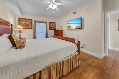 a bedroom with a large bed and a ceiling fan at Majestic Beach Towers 1-407 in Panama City Beach