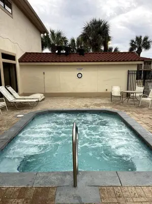 a swimming pool in front of a house at Lazy Palm 4 Pools Short Walk To Beach! Sleeps 5! in Panama City Beach