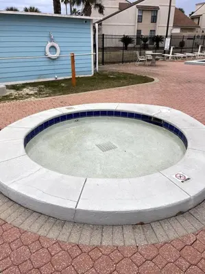a circular pool in the middle of a brick yard at Lazy Palm 4 Pools Short Walk To Beach! Sleeps 5! in Panama City Beach