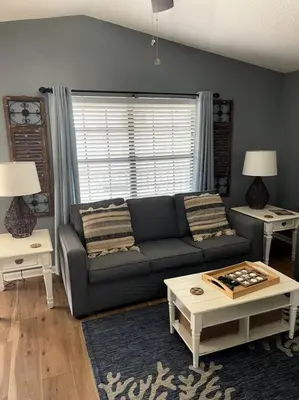 a living room with a couch and two tables at Lazy Palm 4 Pools Short Walk To Beach! Sleeps 5! in Panama City Beach