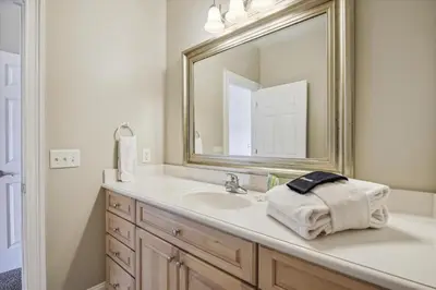 a bathroom with a sink and a large mirror at Second Wind by Book That Condo in Panama City Beach