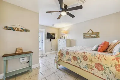 a bedroom with a bed and a ceiling fan at Second Wind by Book That Condo in Panama City Beach