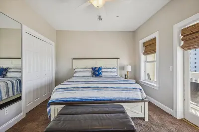 a bedroom with a bed and a window at Second Wind by Book That Condo in Panama City Beach