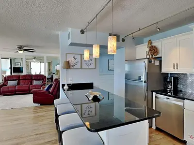 a kitchen and living room with a counter top in a room at Edgewater Leeward #500 in Panama City Beach