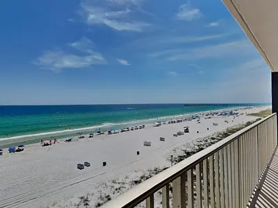a view of a beach with umbrellas and the ocean at Edgewater Leeward #500 in Panama City Beach
