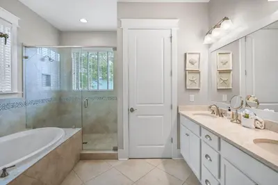 a bathroom with a tub and a sink and a shower at Beach Bliss 30A in Destin