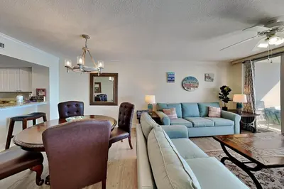 a living room with a couch and a table at Emerald Beach #630 in Panama City Beach