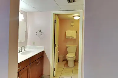 a bathroom with a toilet and a sink at Edgewater Tower II 905 in Panama City Beach