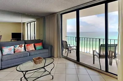 a living room with a couch and a view of the ocean at Edgewater Tower II 905 in Panama City Beach