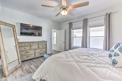 a bedroom with a white bed and a ceiling fan at Inlet Beach Escape about half Mi to Beach Access! in Inlet Beach