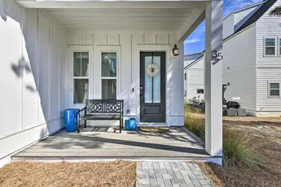 a front door of a white house with a bench at Inlet Beach Escape about half Mi to Beach Access! in Inlet Beach