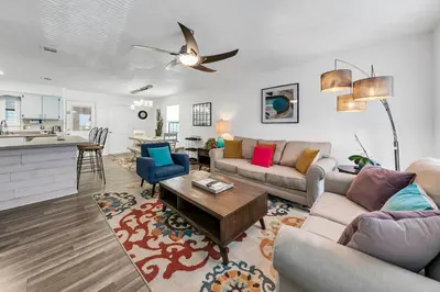 a living room with a couch and a table at Sand Castles West T8 in Panama City Beach