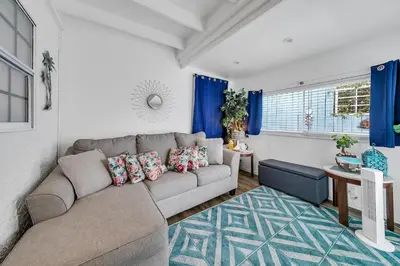 a living room with a couch and a table at Sand Castles West T8 in Panama City Beach
