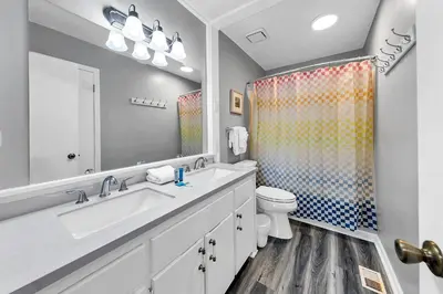 a bathroom with a sink and a toilet and a shower at Sand Castles West T8 in Panama City Beach