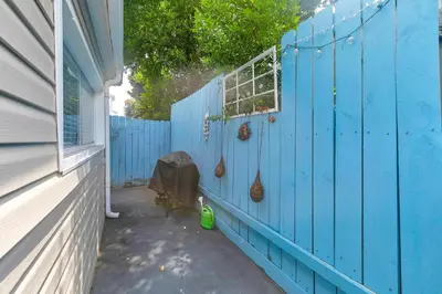 a blue wall next to a house with a window at Sand Castles West T8 in Panama City Beach