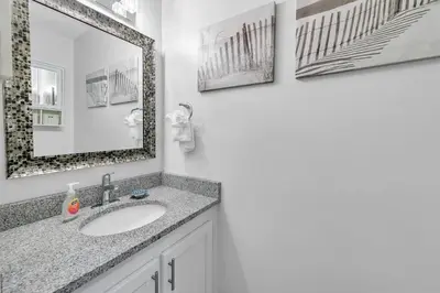 a bathroom with a sink and a mirror at Portside K5 in Panama City Beach