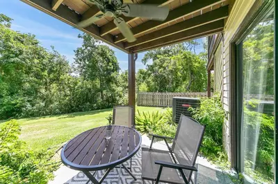 a patio with a table and two chairs at Portside K5 in Panama City Beach