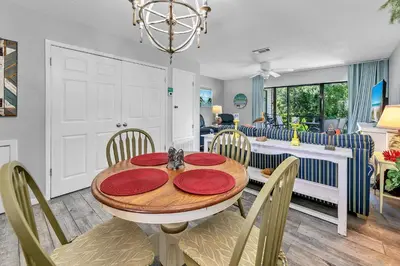 a dining room with a table with red plates on it at Portside K5 in Panama City Beach