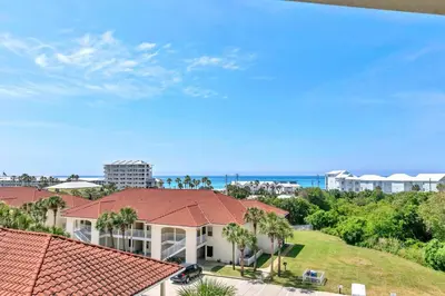 an aerial view of a house with palm trees and the ocean at Horizon South 54-303 in Panama City Beach