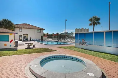 a swimming pool in a yard next to a building at Horizon South 54-303 in Panama City Beach