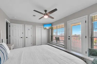 a bedroom with a bed and a ceiling fan at Horizon South 54-303 in Panama City Beach