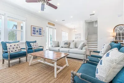 a living room with a couch and a table at Blue Dream in Santa Rosa Beach