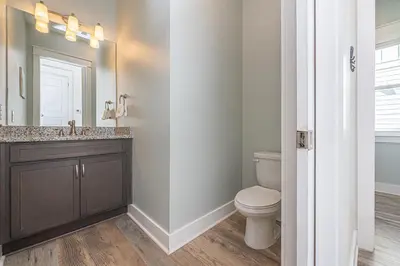 a bathroom with a toilet and a sink and a mirror at Blue Dream in Santa Rosa Beach
