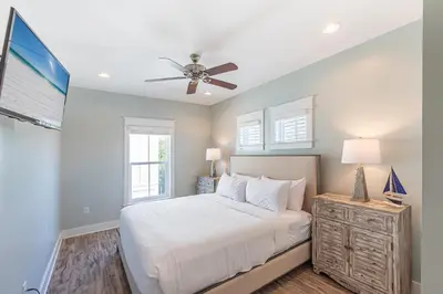 a bedroom with a bed and a ceiling fan at Blue Dream in Santa Rosa Beach