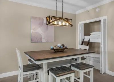 a dining room with a wooden table and chairs at Treasure Island 2102 Beach Front in Panama City Beach
