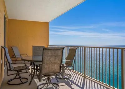 a balcony with a table and chairs and the ocean at Treasure Island 2102 Beach Front in Panama City Beach