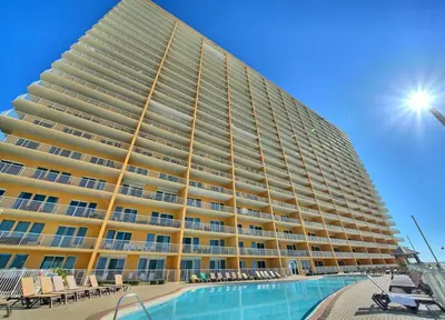 a large building with a swimming pool in front of it at Treasure Island 2102 Beach Front in Panama City Beach