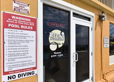 a sign on the door of a restaurant with no driving signs at Treasure Island 2102 Beach Front in Panama City Beach