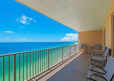 a balcony with chairs and a view of the ocean at Treasure Island 2005 Beach Front in Panama City Beach