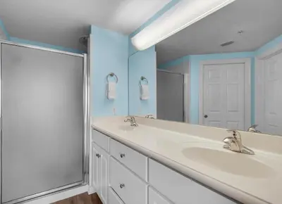 a bathroom with two sinks and a shower at Treasure Island 2005 Beach Front in Panama City Beach