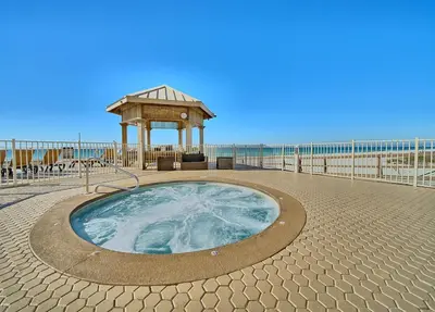 a hot tub with a gazebo next to the beach at Treasure Island 2005 Beach Front in Panama City Beach