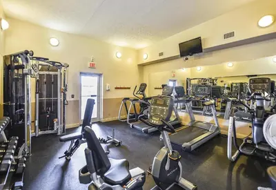 a gym with several treadmills and cardio machines at Treasure Island 2005 Beach Front in Panama City Beach